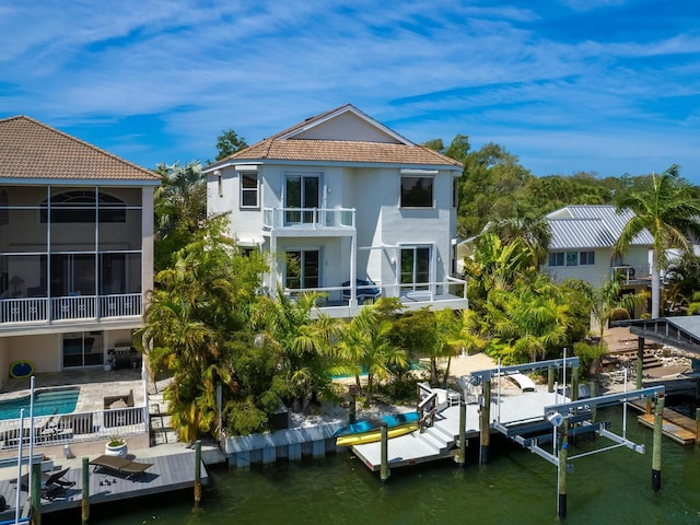 exterior space with a balcony and a water view