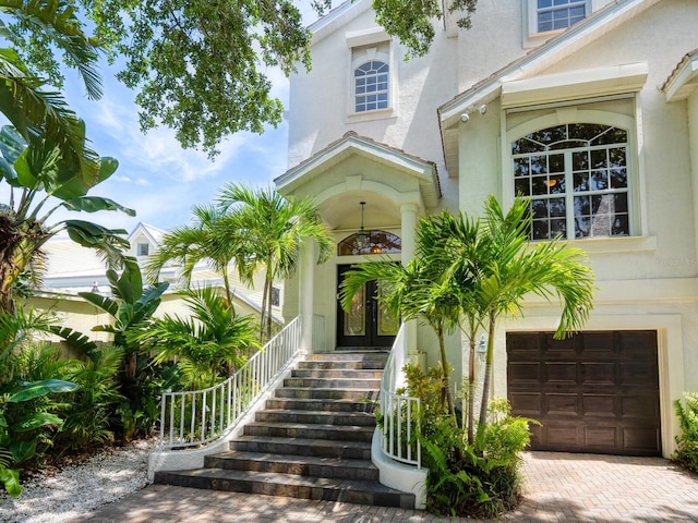 doorway to property with a garage