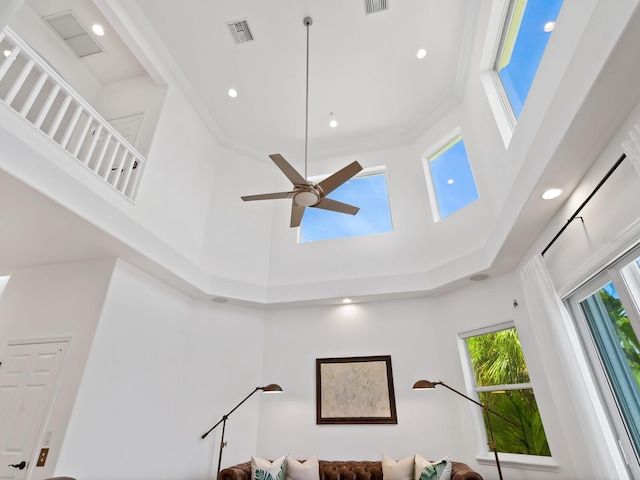 living room featuring a high ceiling and ceiling fan