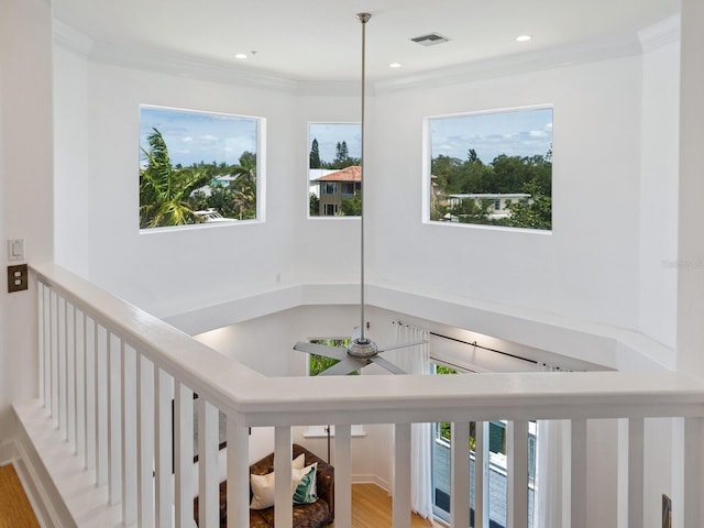 hall featuring light wood-type flooring and crown molding