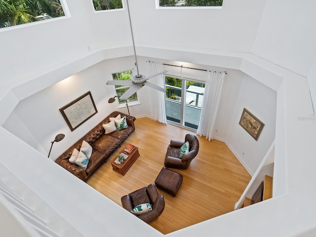 living room featuring a towering ceiling and wood-type flooring