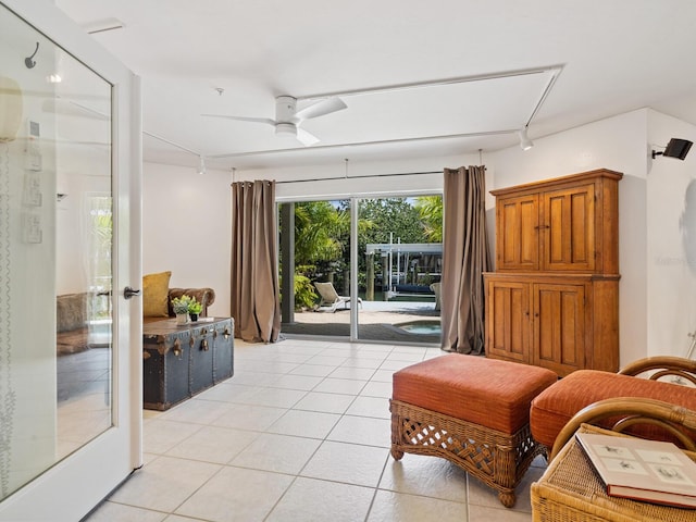 sitting room featuring ceiling fan and light tile patterned floors