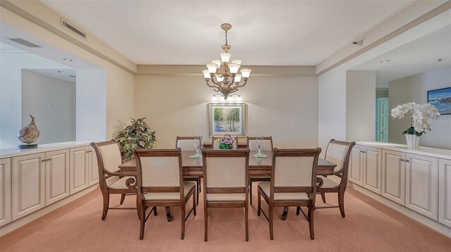 dining area featuring light carpet and a chandelier