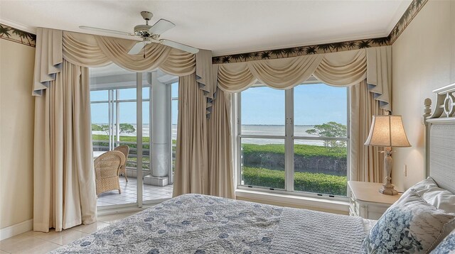 tiled bedroom with multiple windows, ceiling fan, access to exterior, and a water view