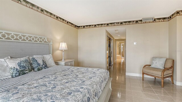 bedroom featuring crown molding and tile flooring