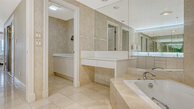 bathroom with tile floors, tiled bath, and large vanity