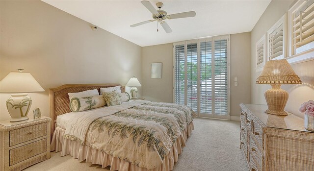 carpeted bedroom with ceiling fan and access to exterior