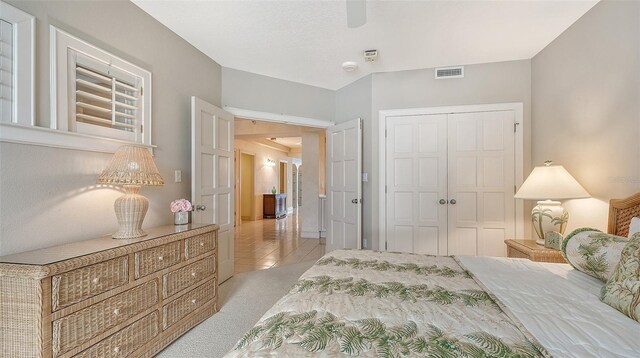 tiled bedroom featuring a closet and ceiling fan