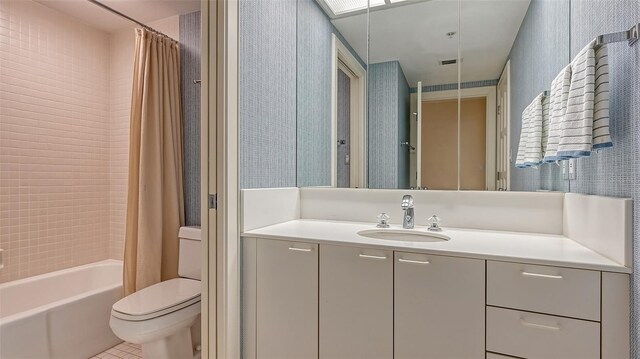 full bathroom featuring shower / bath combo with shower curtain, toilet, tile flooring, and vanity