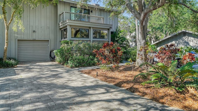 view of front of home featuring a garage and a balcony