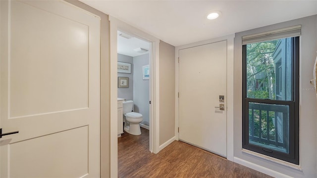 interior space featuring hardwood / wood-style floors and toilet