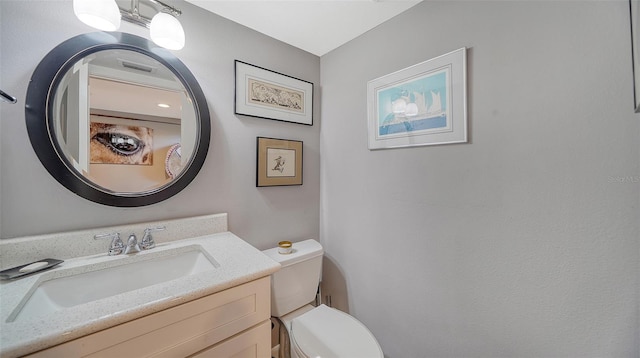 bathroom with toilet and vanity