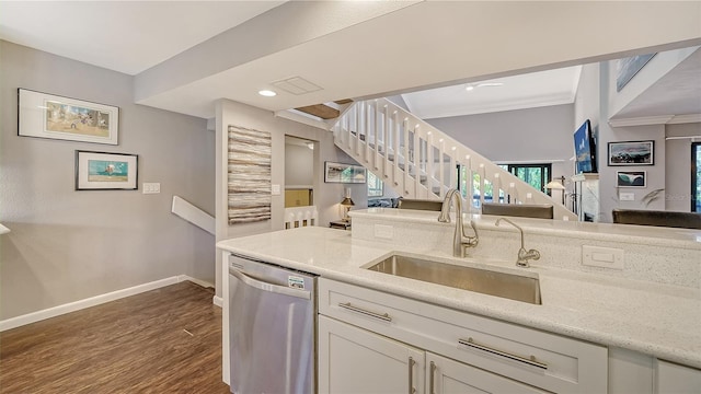 kitchen featuring dishwasher, light stone counters, white cabinets, sink, and dark hardwood / wood-style flooring