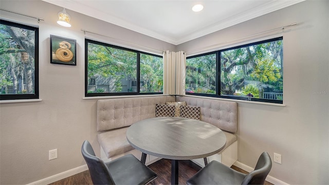 dining space with dark hardwood / wood-style flooring and ornamental molding