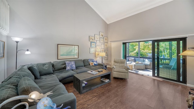 living room with high vaulted ceiling and dark wood-type flooring