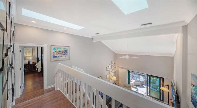 hallway featuring ornamental molding, lofted ceiling with skylight, and dark wood-type flooring