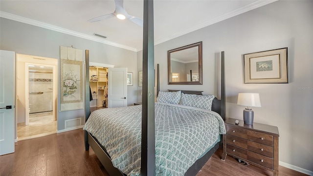 bedroom featuring ornamental molding, ceiling fan, ensuite bathroom, and dark hardwood / wood-style floors