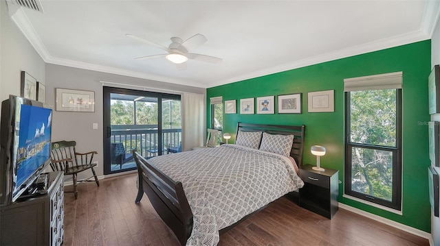 bedroom with dark hardwood / wood-style flooring, crown molding, and multiple windows