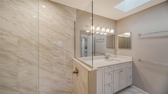 bathroom with a skylight, tile flooring, and large vanity