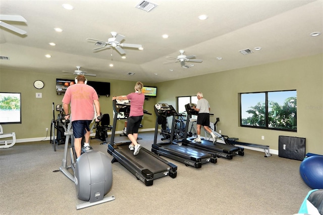 exercise room with light colored carpet and ceiling fan