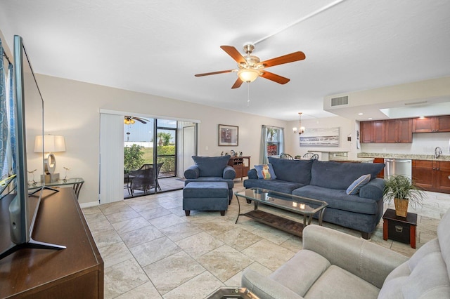 tiled living room with sink and ceiling fan with notable chandelier