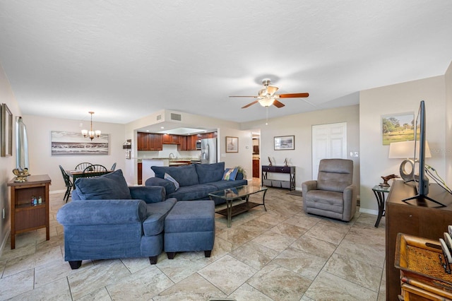 tiled living room featuring ceiling fan with notable chandelier and sink