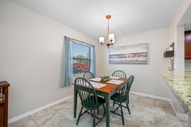 tiled dining area featuring an inviting chandelier