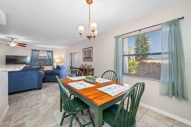 dining room with ceiling fan with notable chandelier and light tile floors