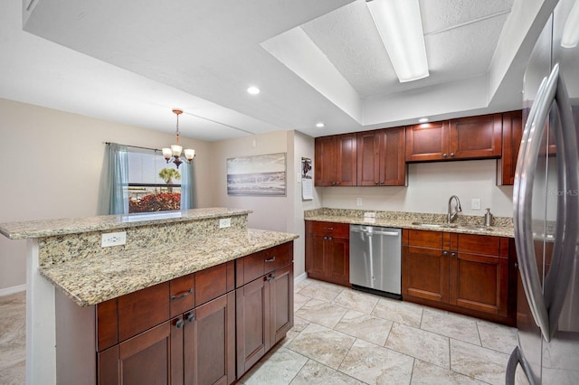 kitchen with decorative light fixtures, stainless steel appliances, light tile floors, sink, and a raised ceiling