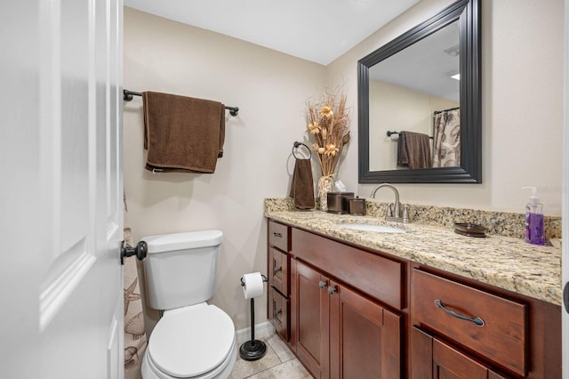 bathroom with vanity, toilet, and tile flooring