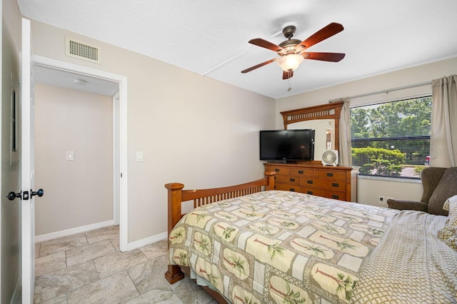 tiled bedroom with ceiling fan