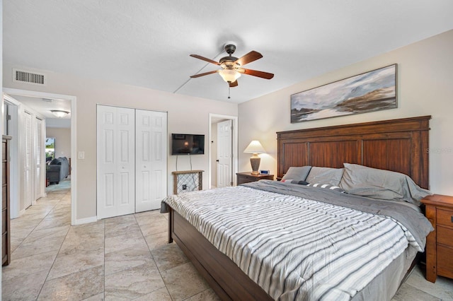 bedroom featuring a closet, ceiling fan, and light tile flooring