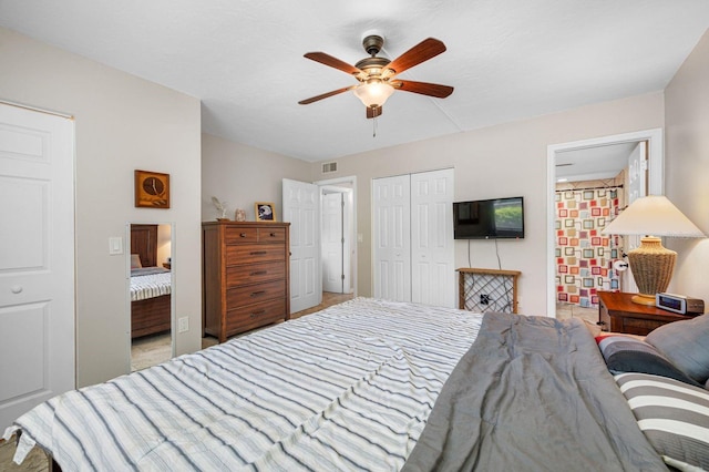 bedroom with ceiling fan and light carpet