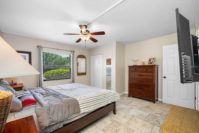 bedroom featuring a closet, ceiling fan, and light tile floors