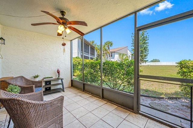 sunroom featuring ceiling fan and a wealth of natural light