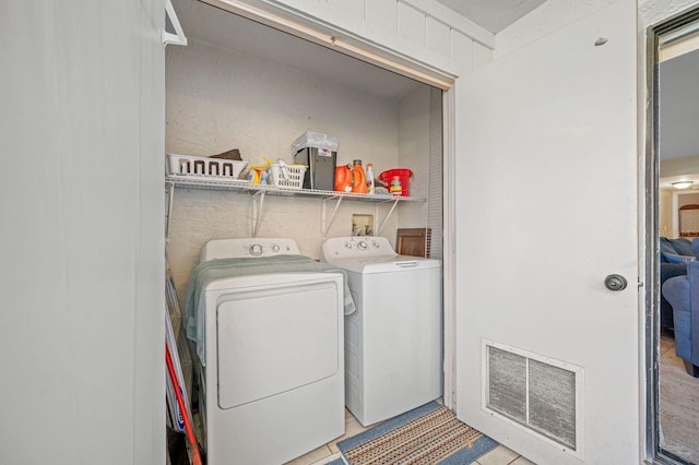 laundry room featuring hookup for a washing machine, separate washer and dryer, and light tile floors