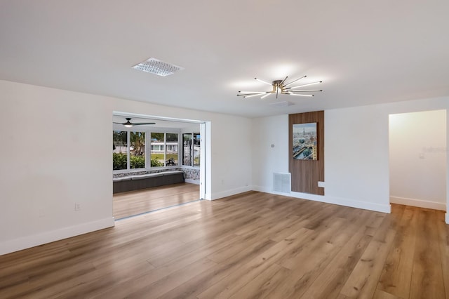 empty room with light hardwood / wood-style flooring and ceiling fan