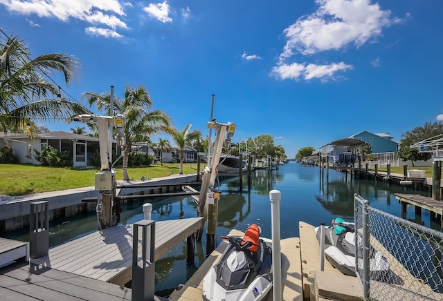 view of dock featuring a yard and a water view