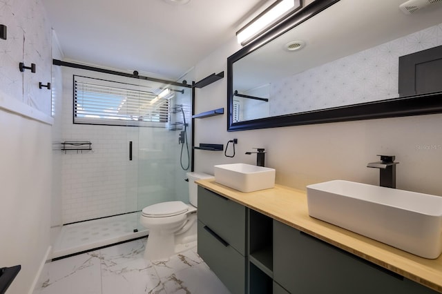 bathroom featuring a shower with door, vanity, toilet, and tile flooring