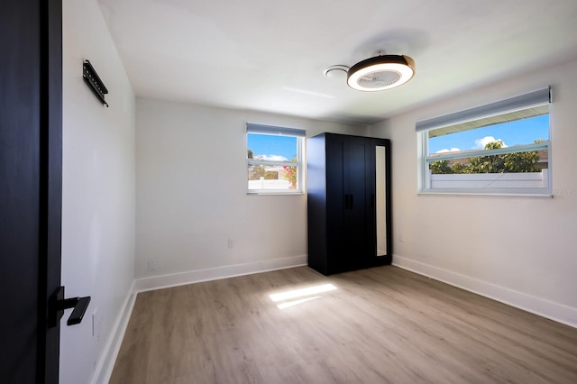 unfurnished room with light hardwood / wood-style floors