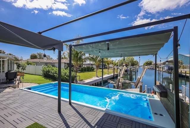 view of swimming pool featuring a yard, a water view, and a dock