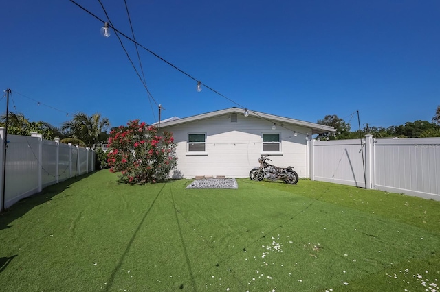 rear view of house with a lawn