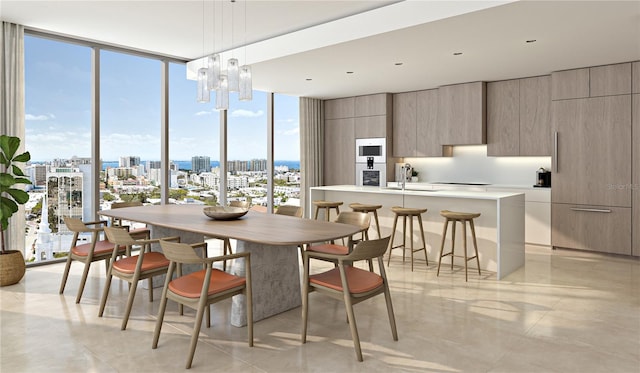 dining area with plenty of natural light, a notable chandelier, light tile floors, and a wall of windows