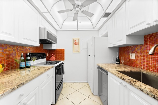 kitchen featuring white cabinets, backsplash, light tile floors, and stainless steel appliances