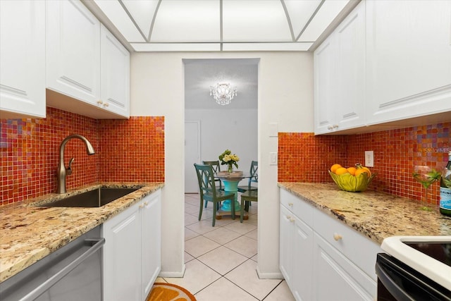 kitchen with stainless steel dishwasher, sink, tasteful backsplash, and white cabinets