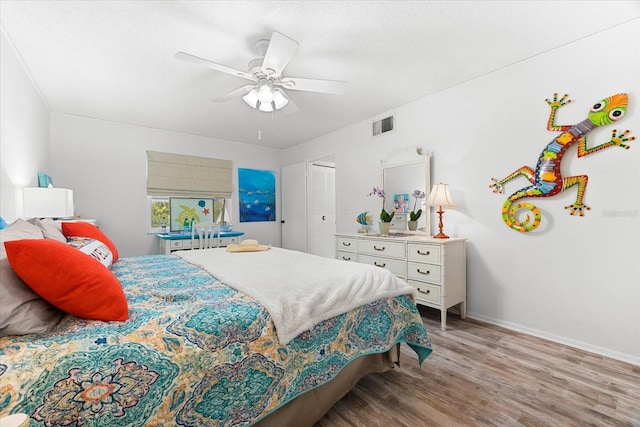 bedroom with a closet, ceiling fan, and hardwood / wood-style floors