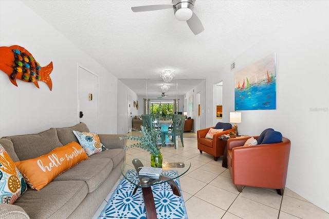 living room with ceiling fan, tile floors, and a textured ceiling