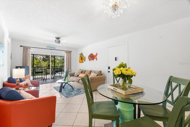 dining space with ceiling fan with notable chandelier, a textured ceiling, and light tile flooring