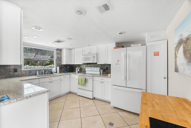 kitchen featuring backsplash, white cabinets, white appliances, and sink