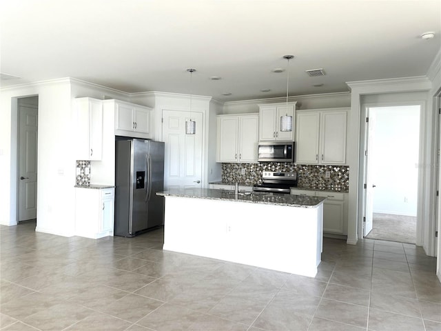 kitchen with appliances with stainless steel finishes, dark stone countertops, decorative light fixtures, and white cabinetry